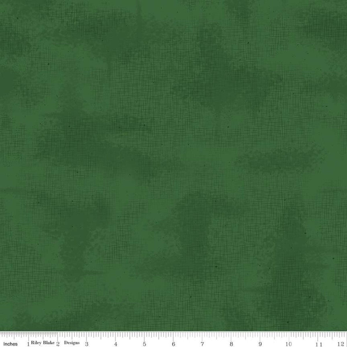 Solid green fabric texture with a ruler at the bottom for scale.