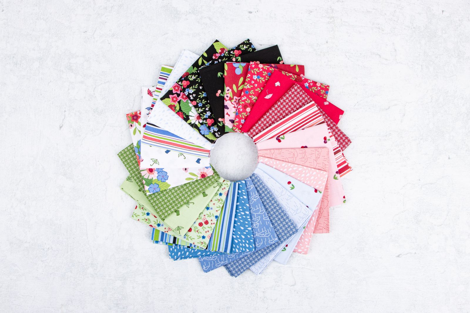Collection of colorful fabric swatches arranged in a circular pattern on a white background