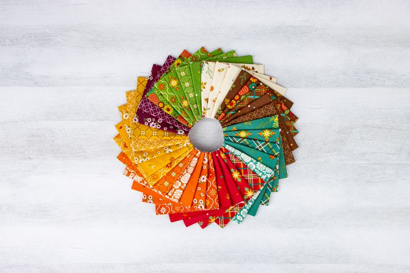 Circular arrangement of colorful fabric swatches on a textured white background