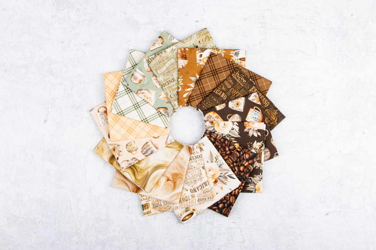 Collection of patterned fabric squares arranged in a circular fashion on a light background