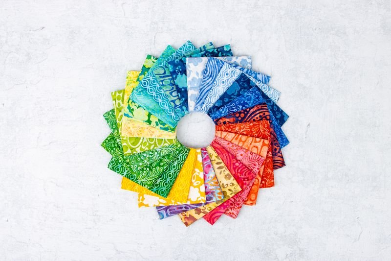 Colorful fabric swatches arranged in a circular pattern on a white background