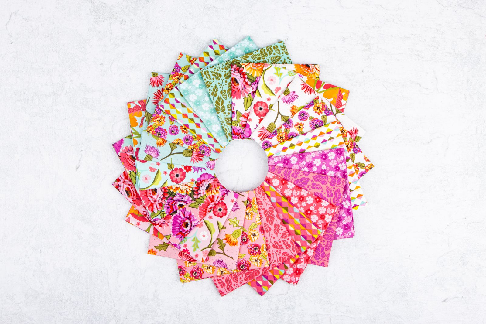 Circular arrangement of colorful fabric swatches on a white background